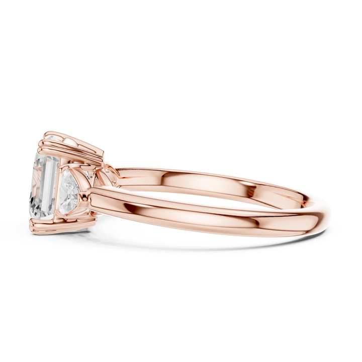 Side profile of rose gold Asscher three-stone ring with half-moon side stones and elevated setting