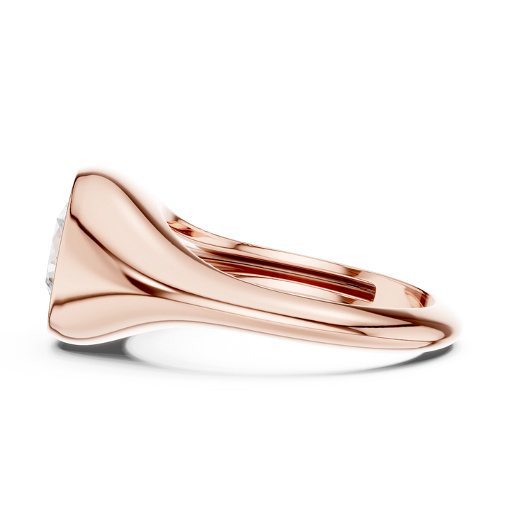 Side view of rose gold round cut bezel set signet ring, highlighting overall design profile.
