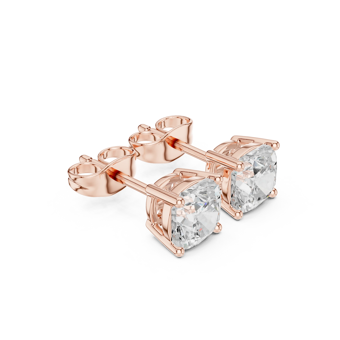 Rose gold earrings with clear gemstones on a white background with top view