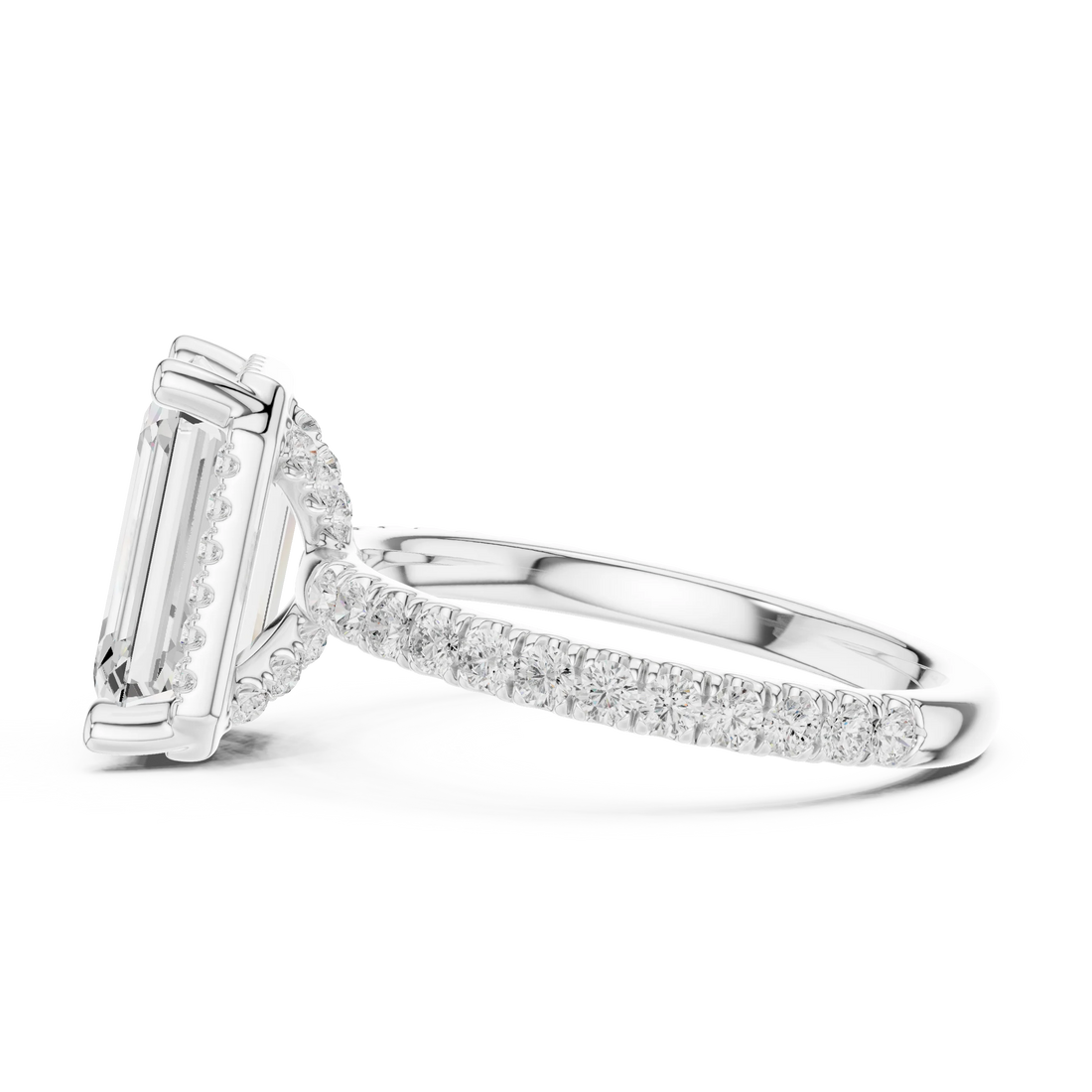 Side view of white gold emerald cut solitaire ring highlighting hidden halo and thin pavé band design