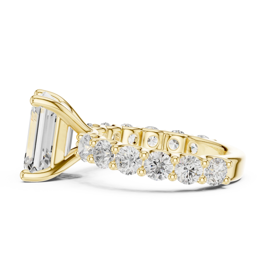 Side view of yellow gold emerald cut solitaire ring with shared prong large stone band and prong setting