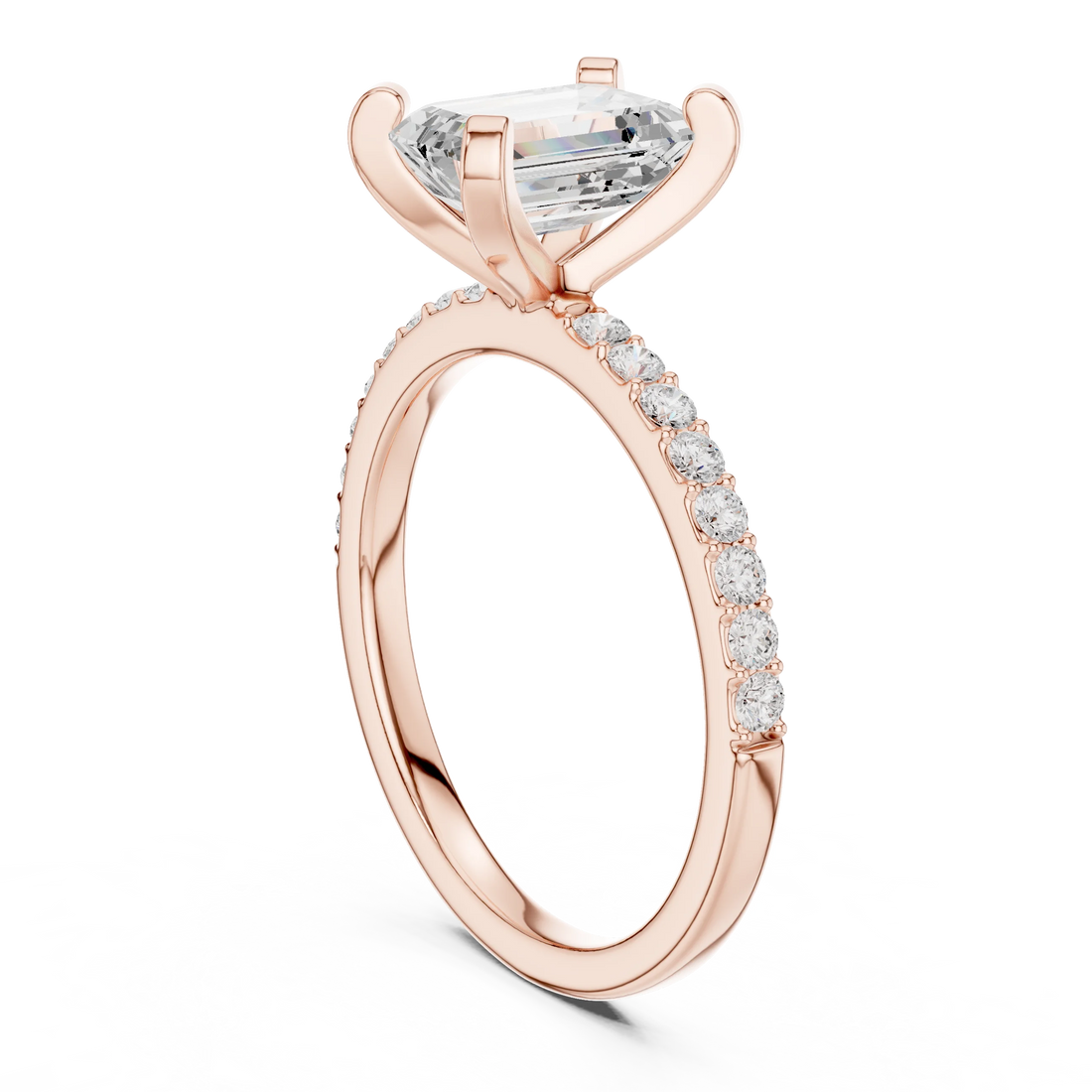 Back side view of rose gold emerald solitaire ring showing thin pavé band and setting details