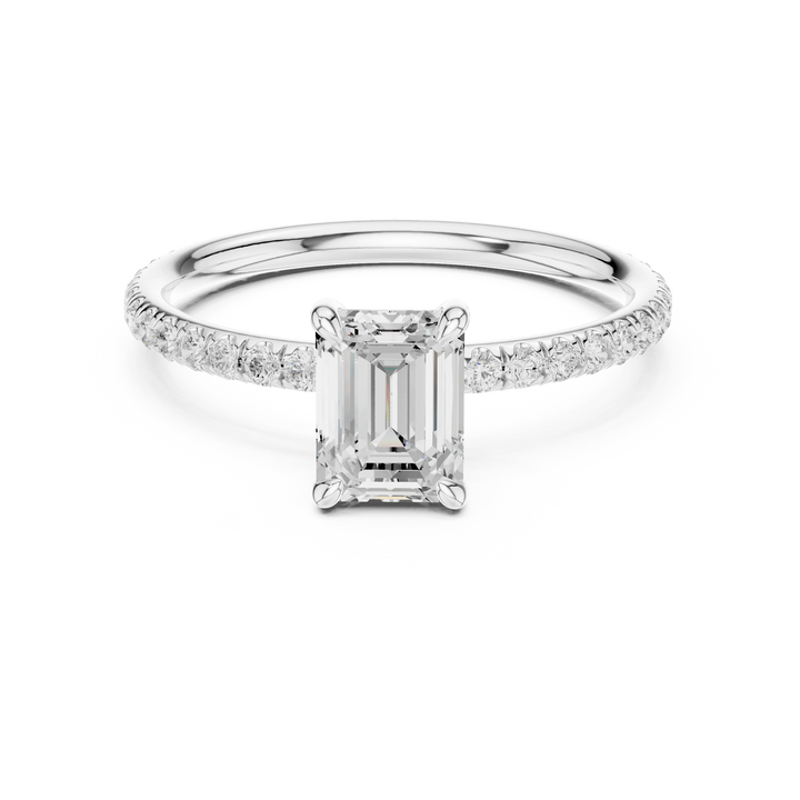 Lab-grown emerald cut solitaire ring in white gold with thin pavé diamond band