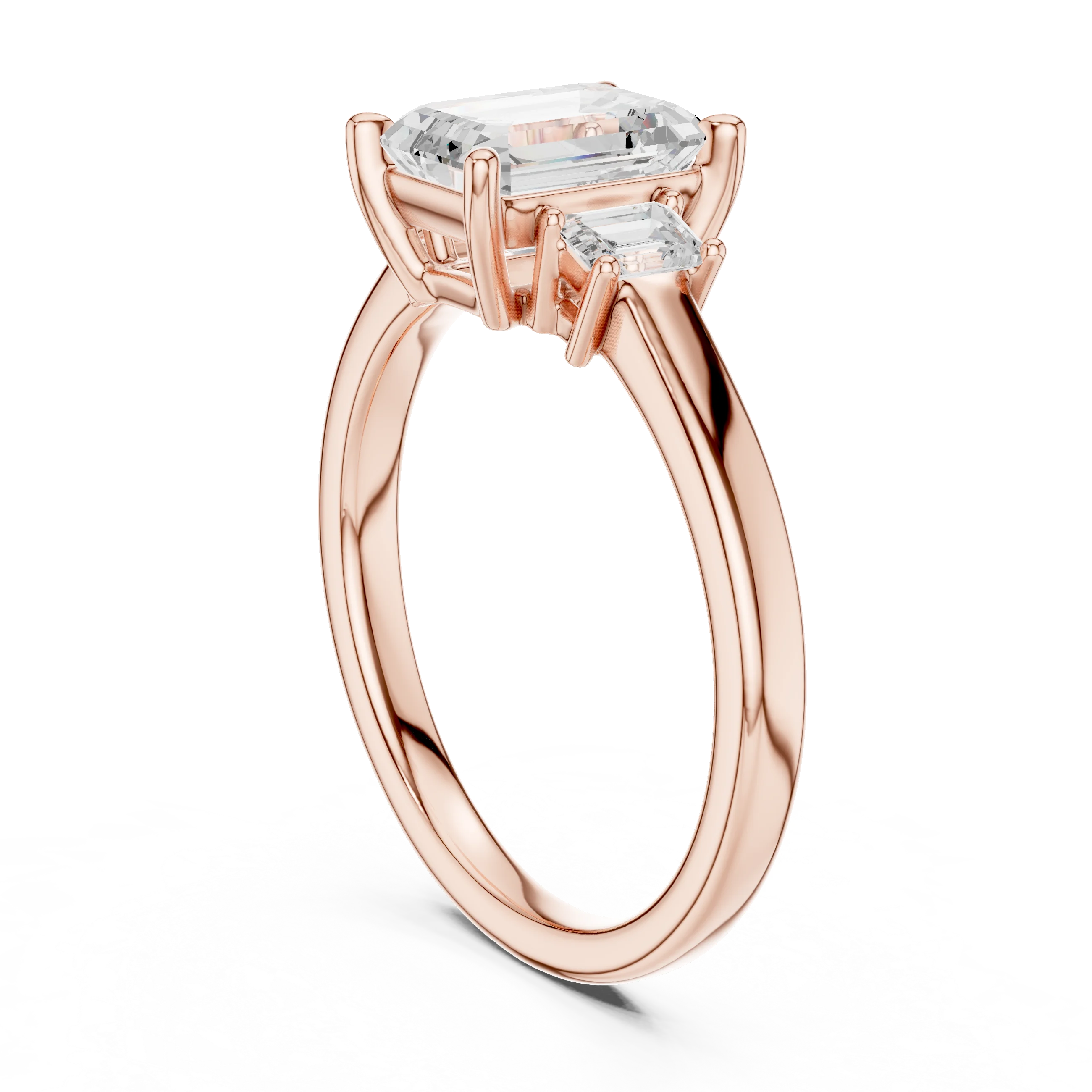 Back side view of rose gold emerald three stone diamond ring, detailing band and setting.