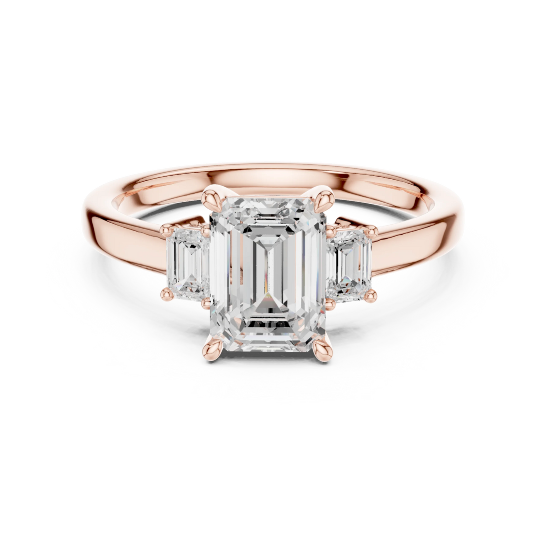 Lab-grown emerald cut three stone diamond ring in rose gold, soft tone top view.