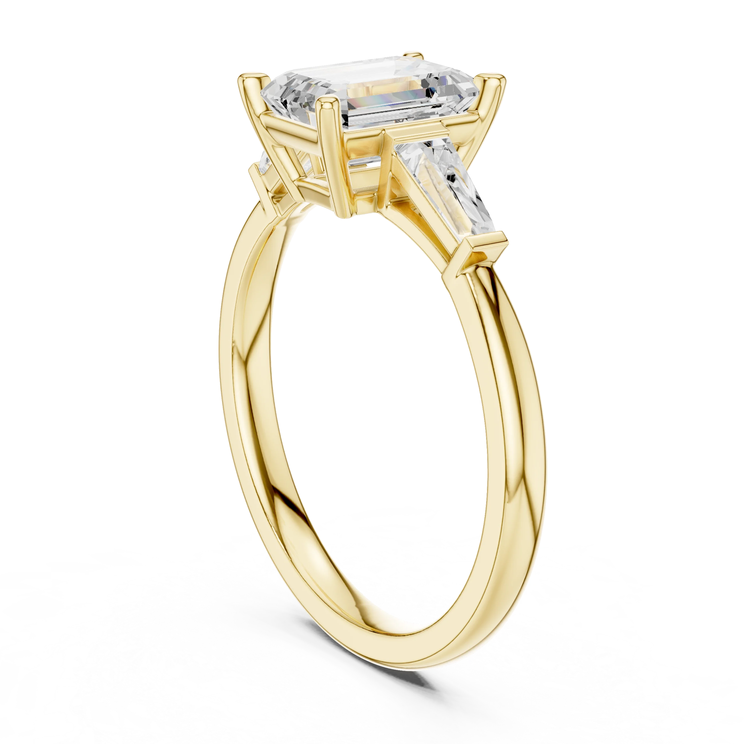 Yellow gold emerald three-stone ring with tapered baguette side stones back view