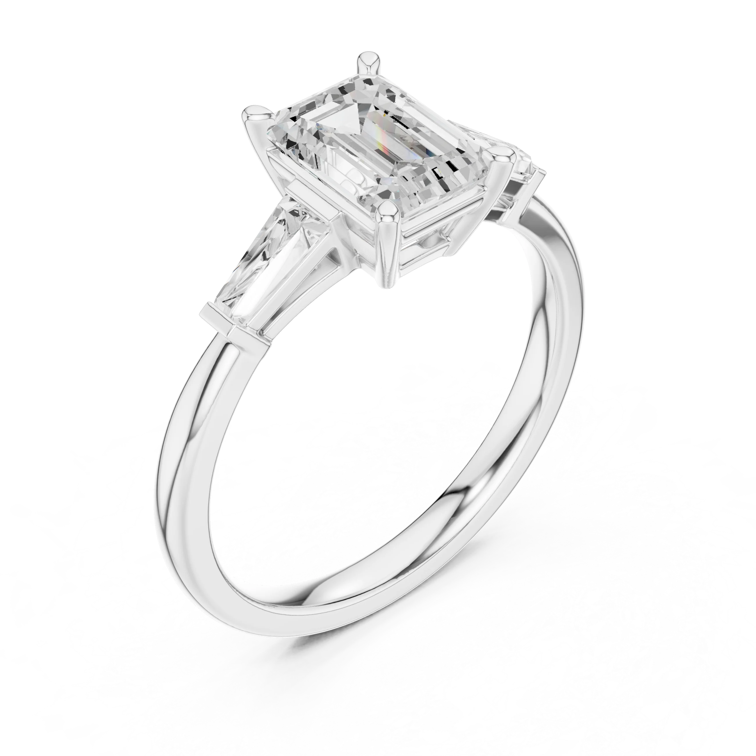 White gold emerald three-stone ring with tapered baguette side stones top side view