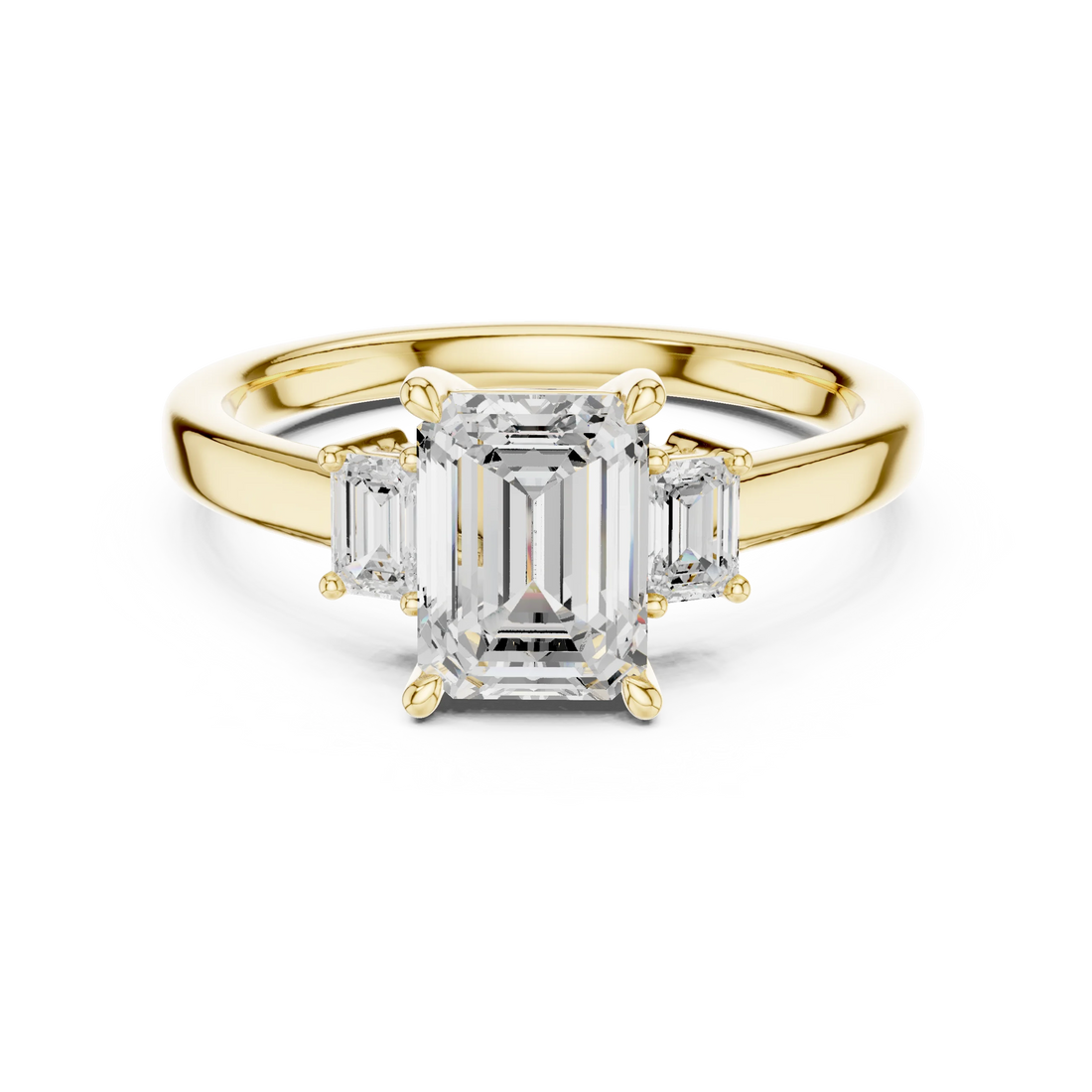 Lab-grown emerald cut three stone diamond ring in yellow gold, classic top view.