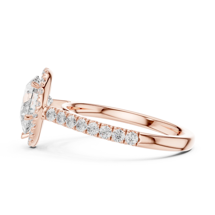 Side view of rose gold pear cut diamond ring with halo setting showcasing elegant band and elevated center stone