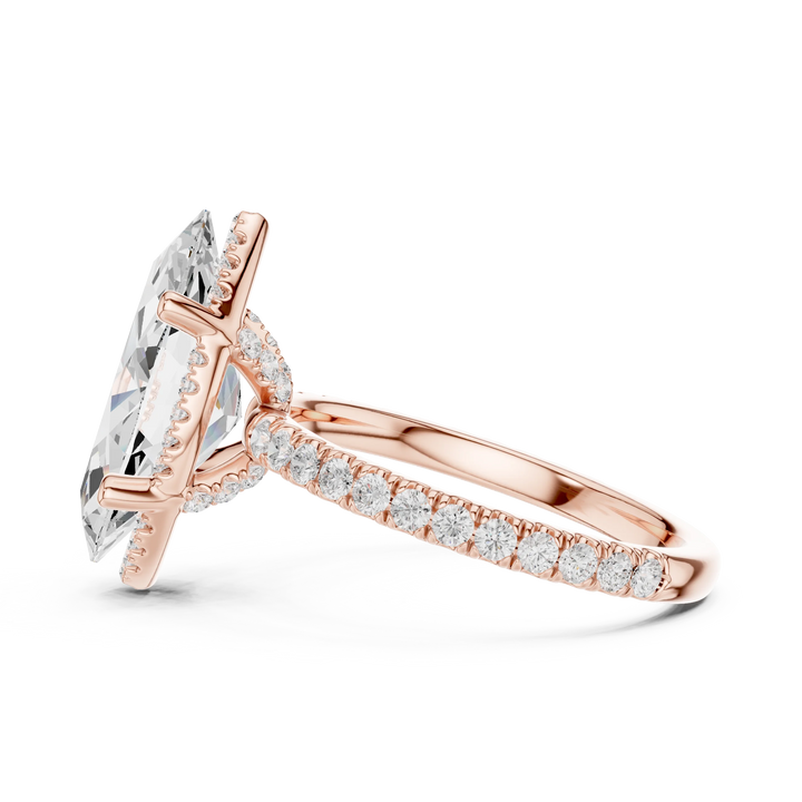 Side view of rose gold marquise cut solitaire ring highlighting hidden halo and thin pavé band design
