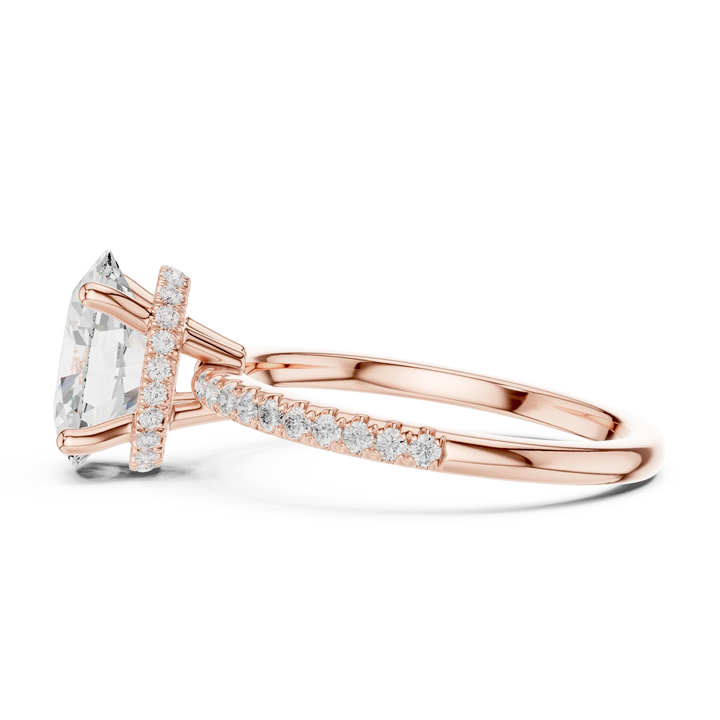 Side view of rose gold oval cut solitaire ring highlighting thin pave band and prong setting