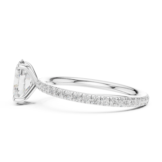 Side view of white gold oval cut solitaire ring with thin pavé diamond band and raised setting