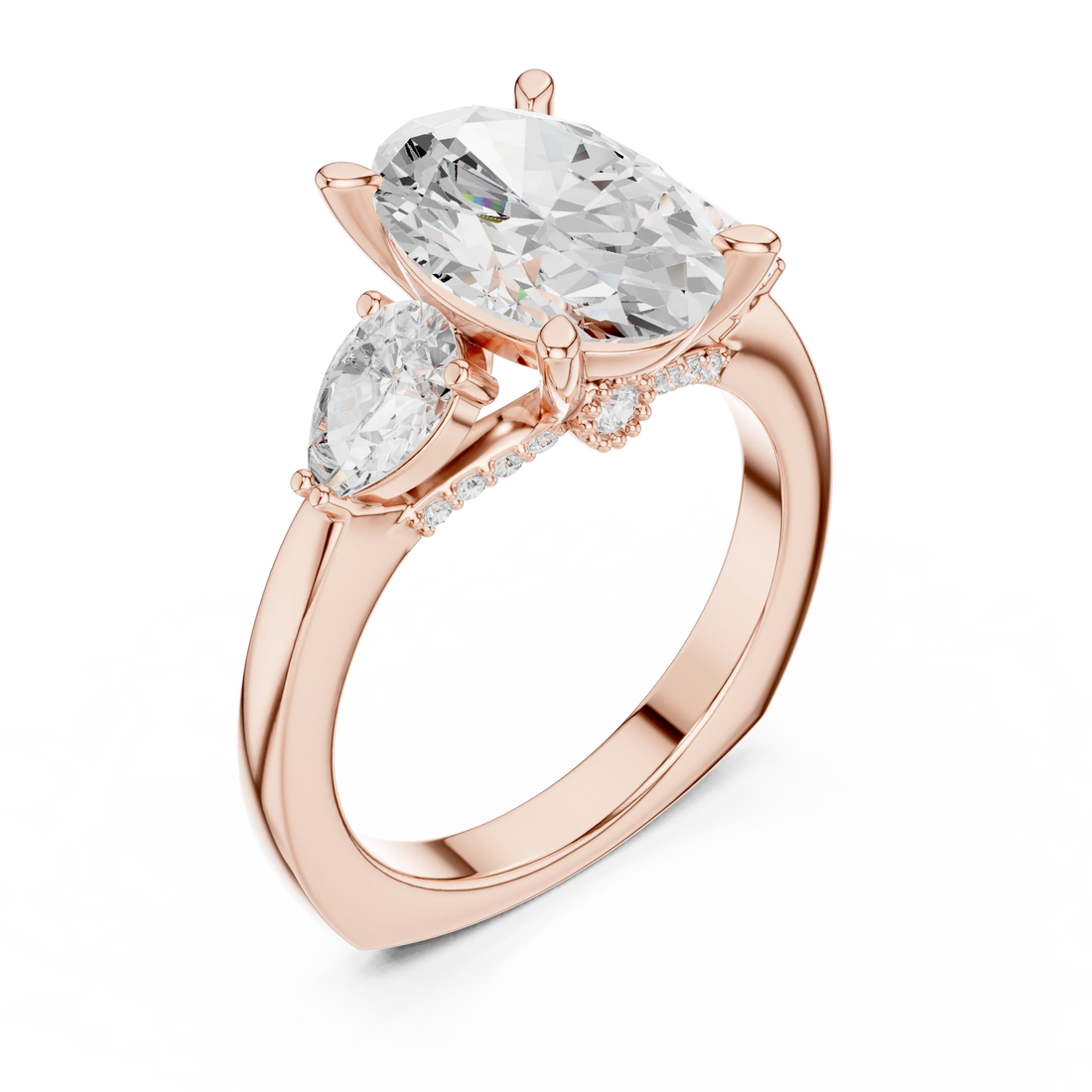 Front view of rose gold oval three stone ring with pear side stones and lab-grown diamonds


