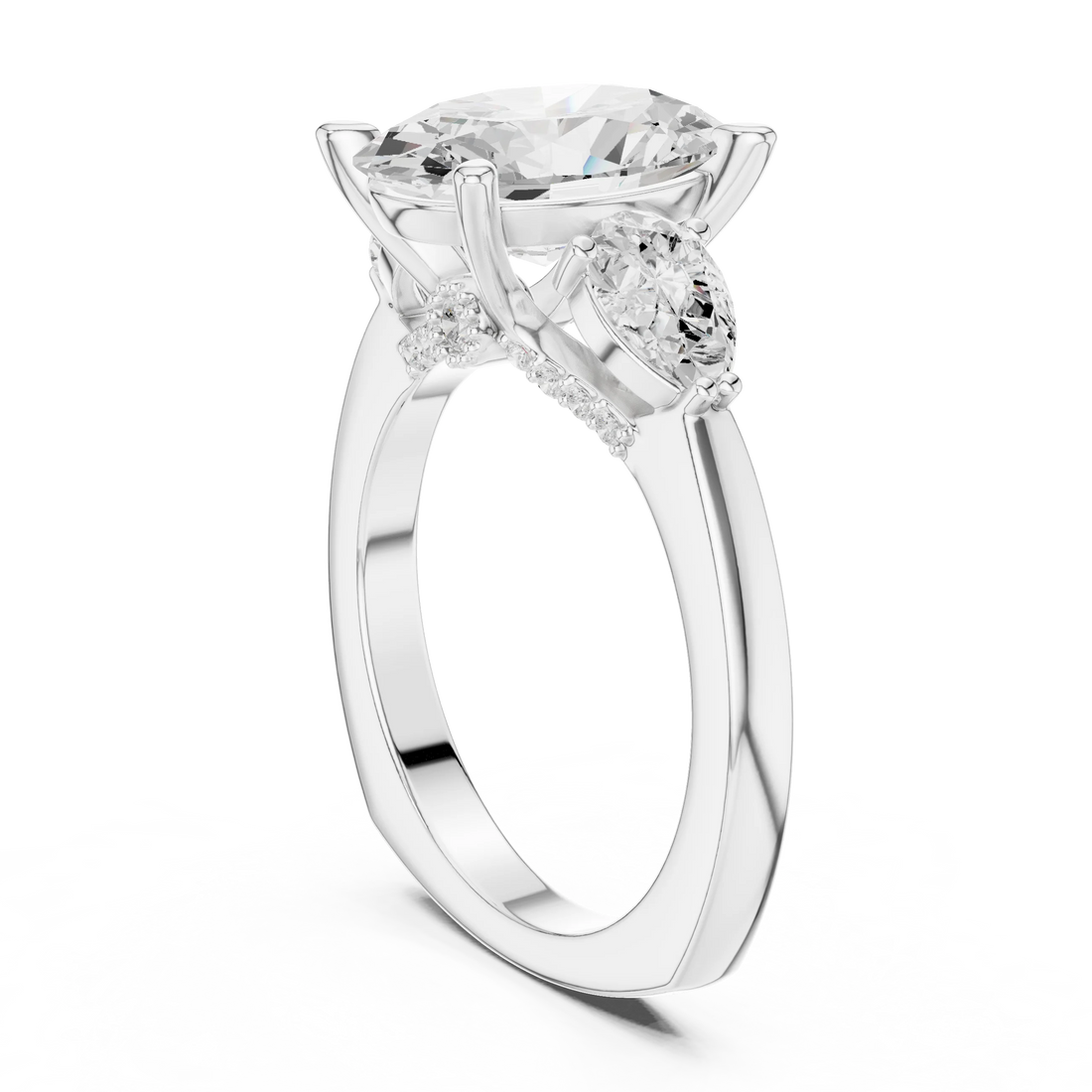 Back view of white gold oval three stone ring featuring pear side stones and polished band