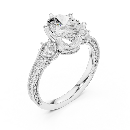 Front view of white gold oval three stone vintage ring with round brilliant side stones and filigree milgrain detailing
