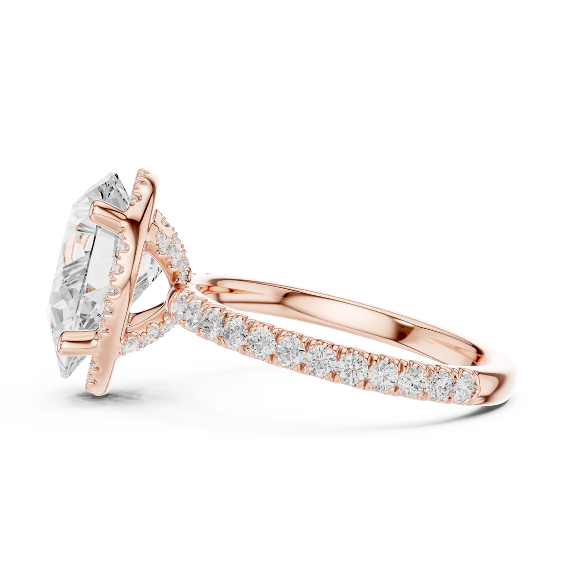 Side view of rose gold pear cut solitaire ring highlighting hidden halo and thin pavé band design