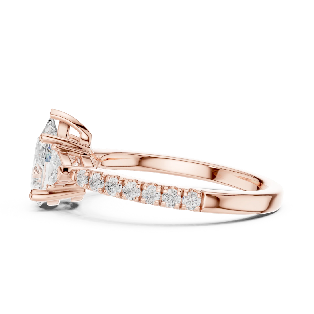 Side view of rose gold pear three stone diamond ring with half moon side stones and pave band, highlighting overall design profile.