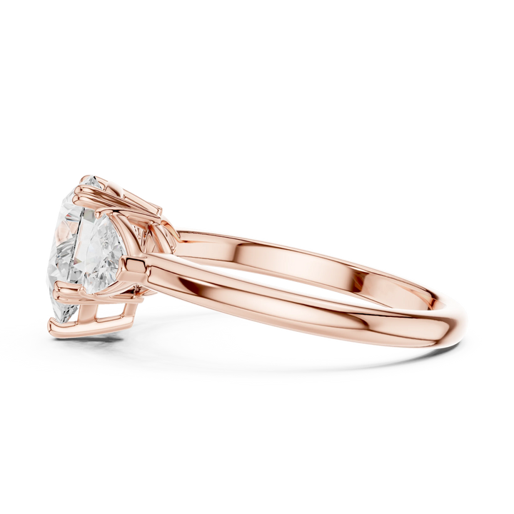 Side view of rose gold pear three-stone ring with trillion cut side stones and lab-grown diamond – Australia