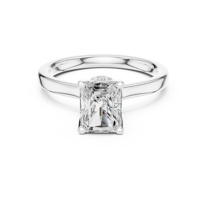 White gold radiant cut solitaire ring with hidden halo and domed band featuring lab-grown diamond, elegant design