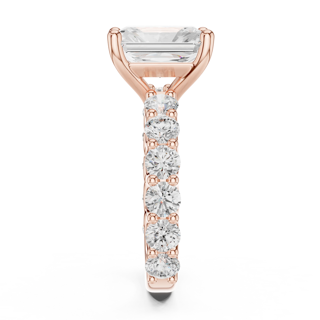 Side profile of rose gold radiant cut solitaire ring with shared prong large stone band and elevated center stone