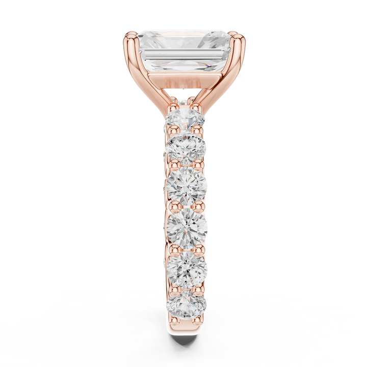 Side profile of rose gold radiant cut solitaire ring with shared prong large stone band and elevated center stone