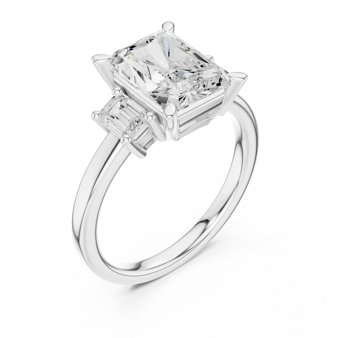 Front view of white gold radiant three stone ring with step cut trapezoid side stones and lab-grown diamonds
