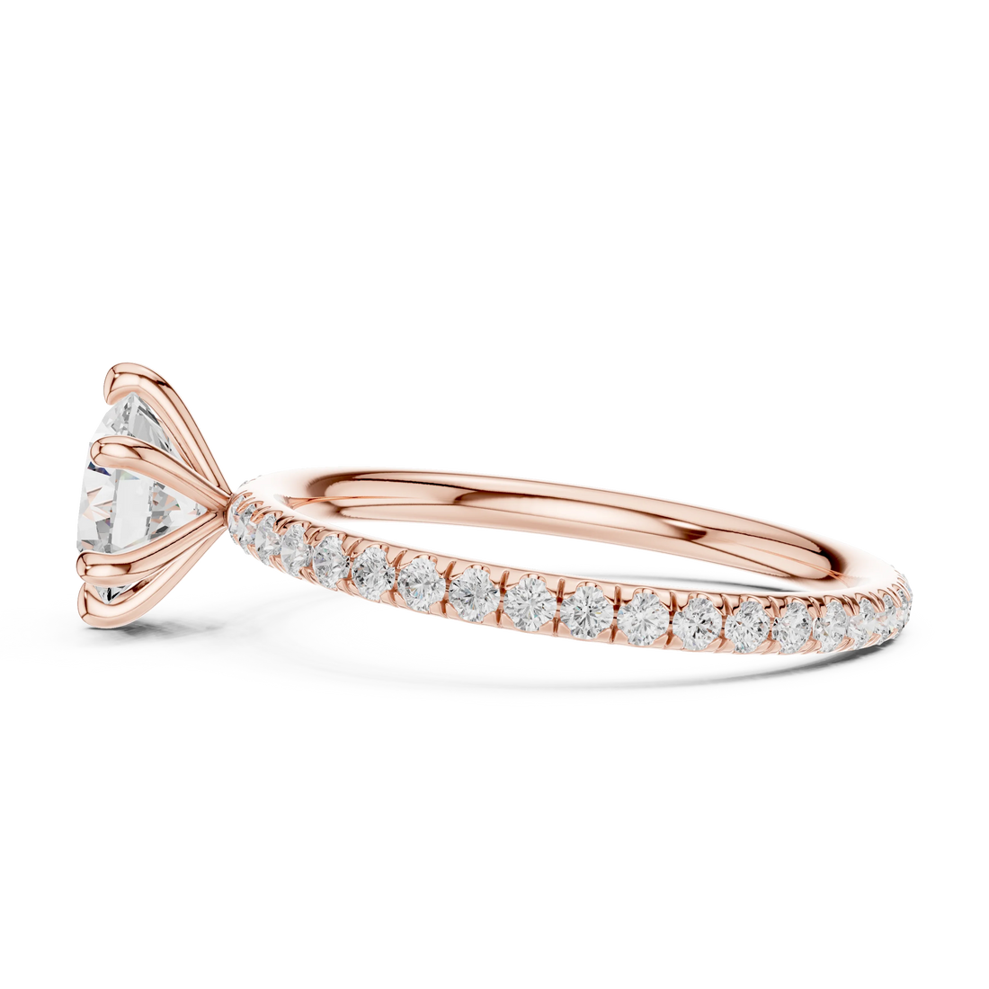Side profile of rose gold round cut solitaire ring with thin pavé diamond band and elevated center stone