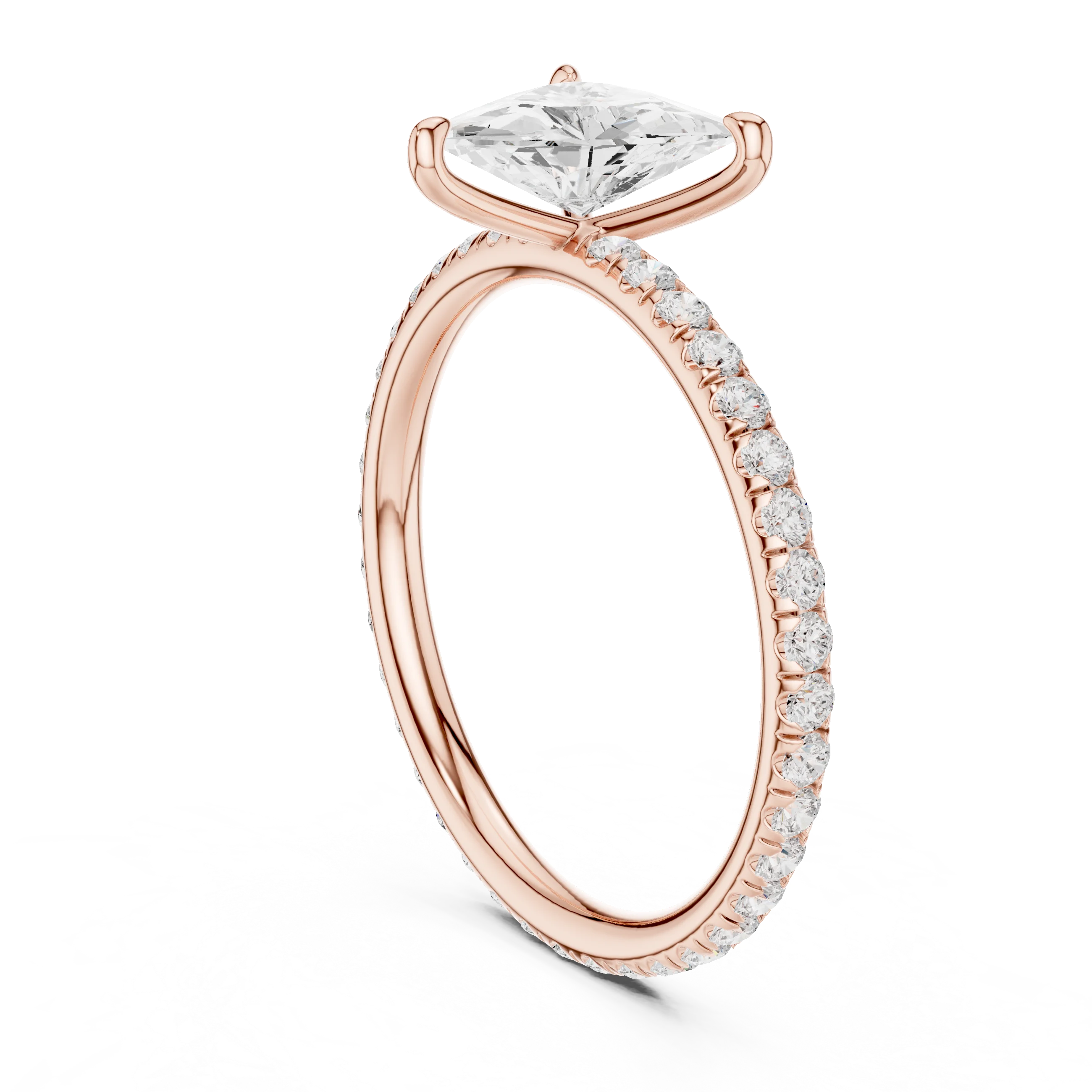 Back side view of rose gold trillion cut solitaire ring showing pavé band and setting details