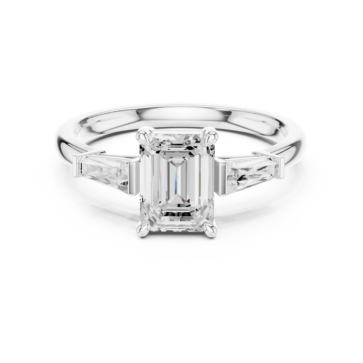 white gold luxe trinity ring with emerald center stone and diamond side stones
