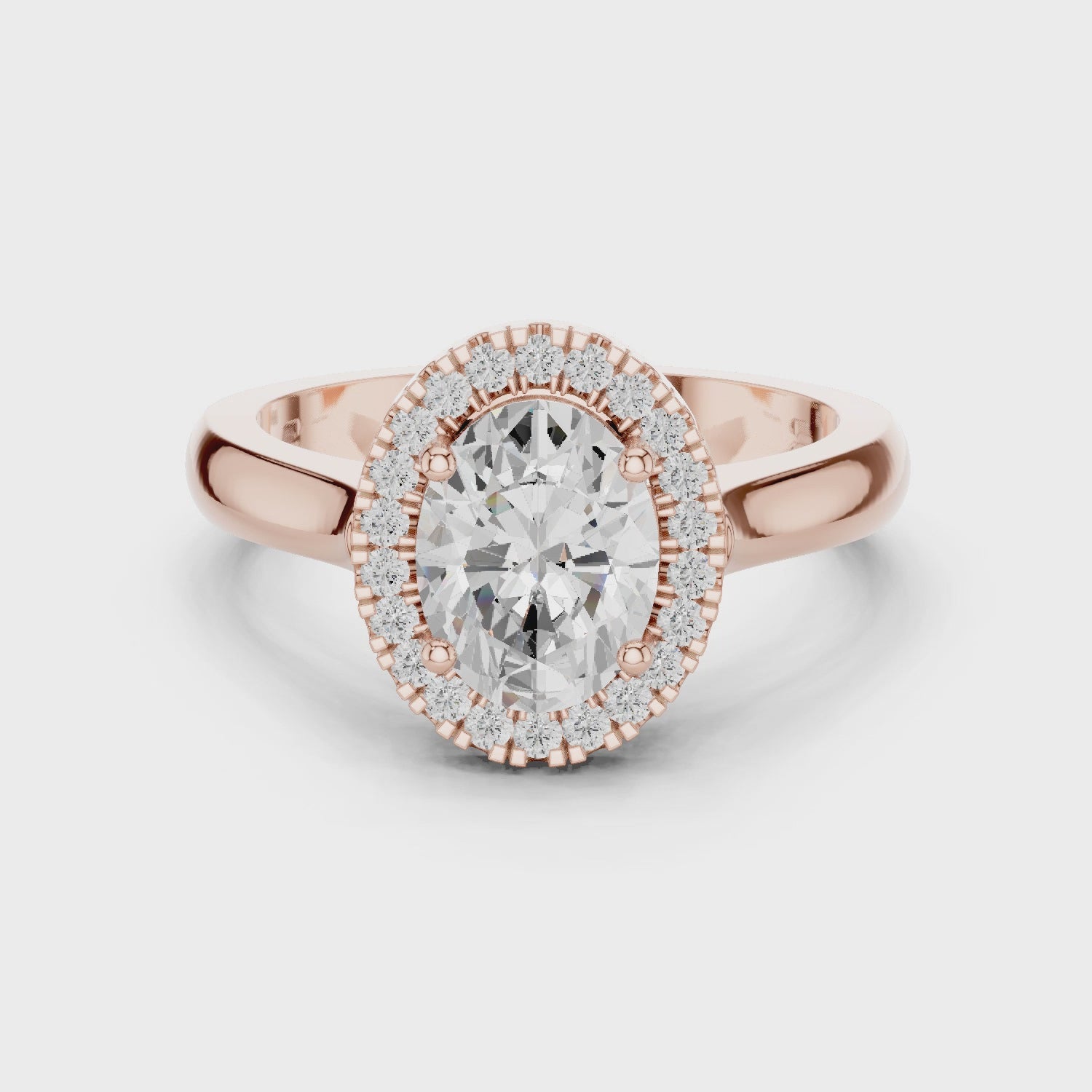 Video of rose gold oval halo ring highlighting diamond setting and band profile