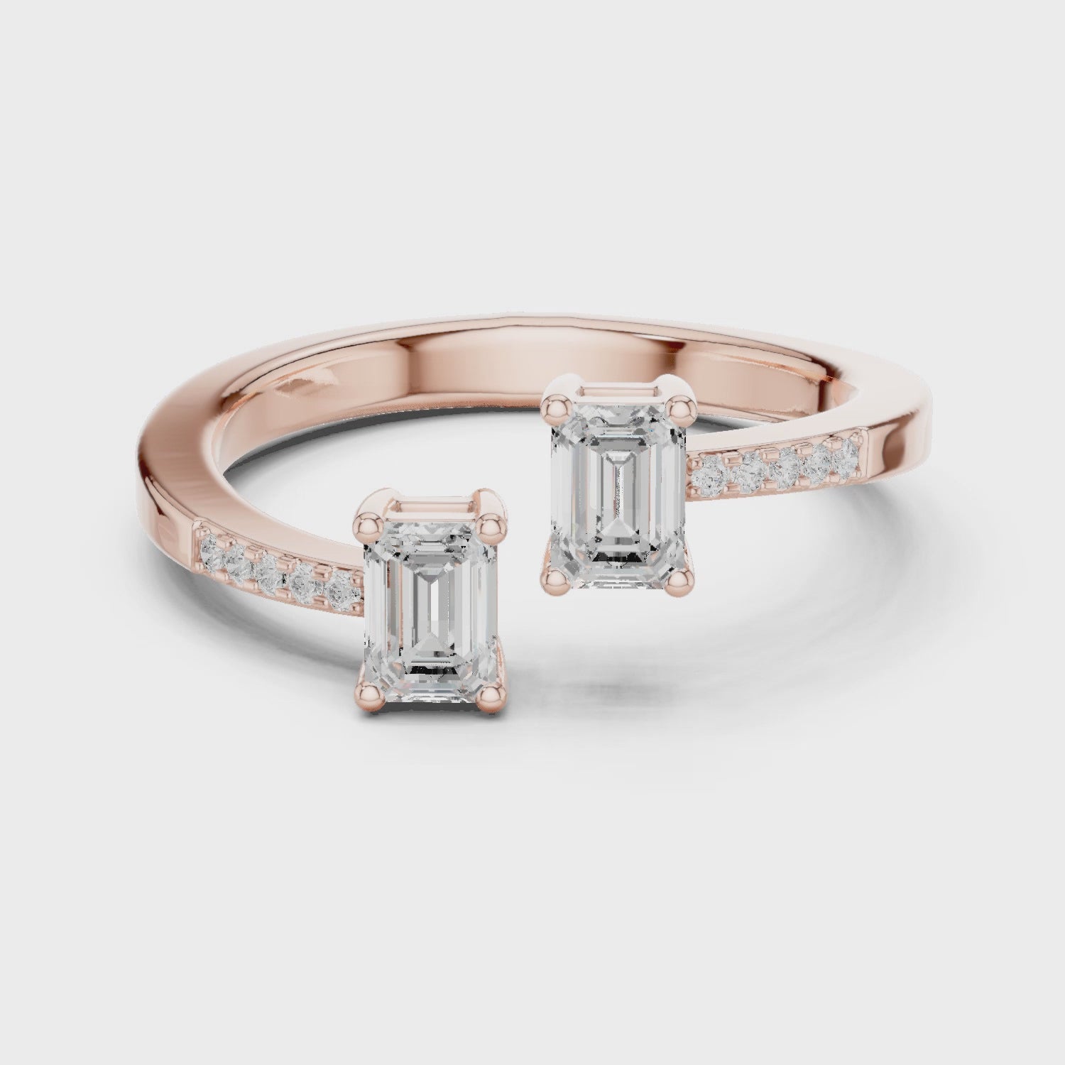 Video of rose gold two stone ring highlighting double emerald setting and pavé band