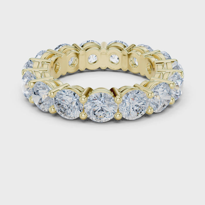 Video of yellow gold eternity band highlighting round diamond setting