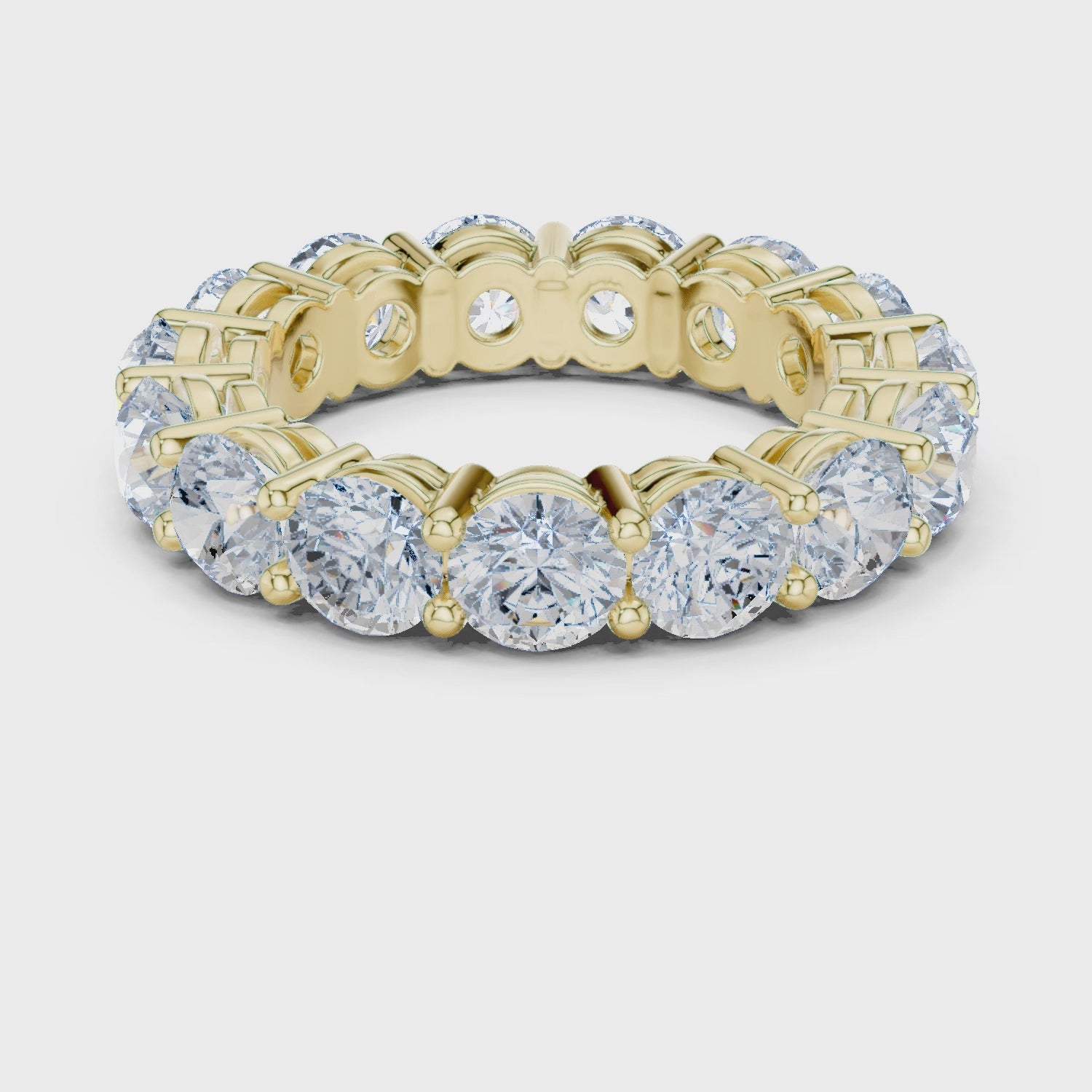 Video of yellow gold eternity band highlighting round diamond setting