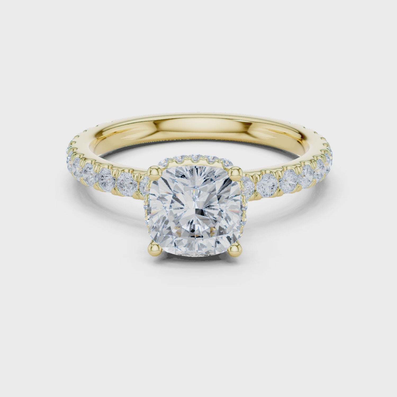Video of cushion cut hidden halo ring with pave diamond band in yellow gold