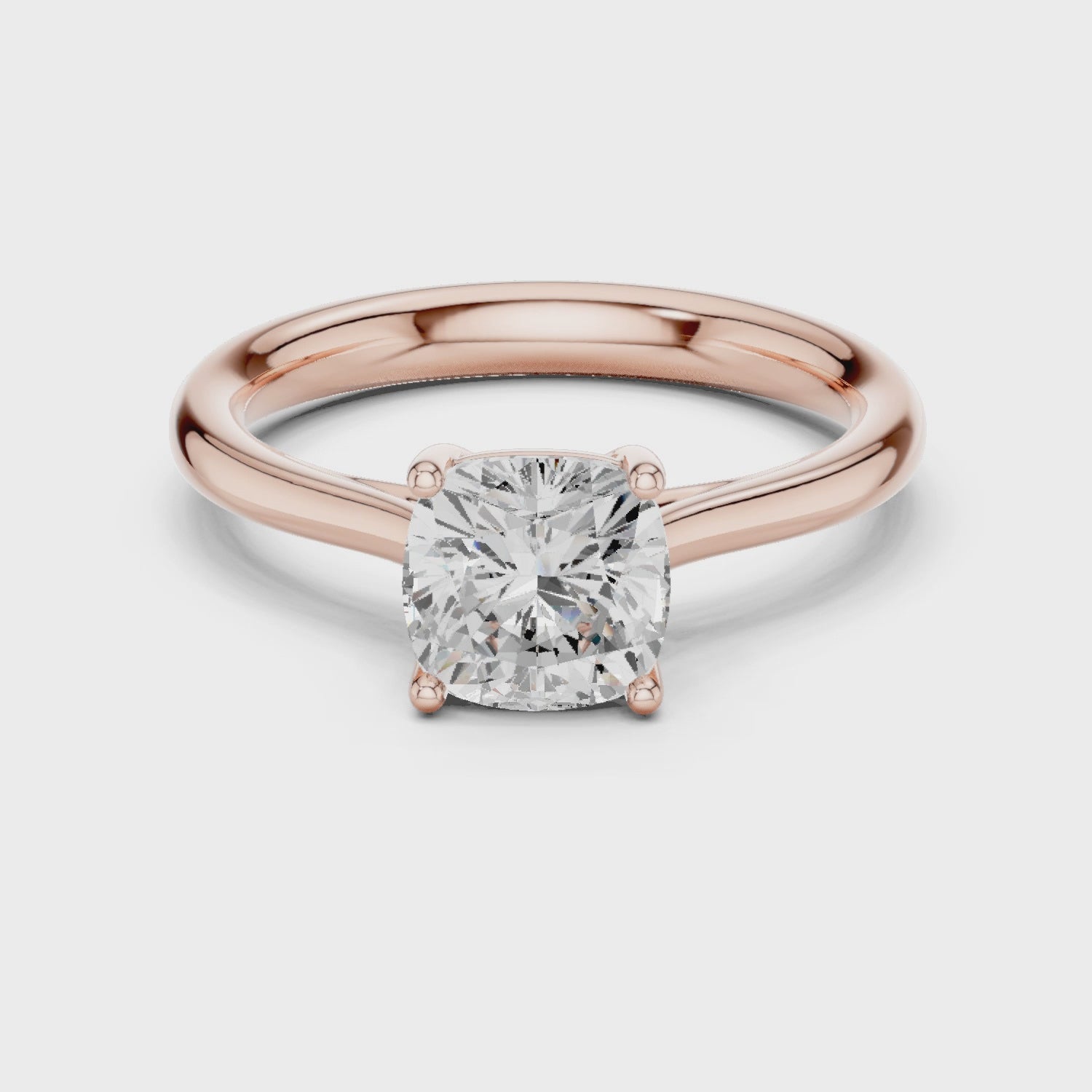Video of rose gold cushion cut solitaire ring highlighting setting and band structure