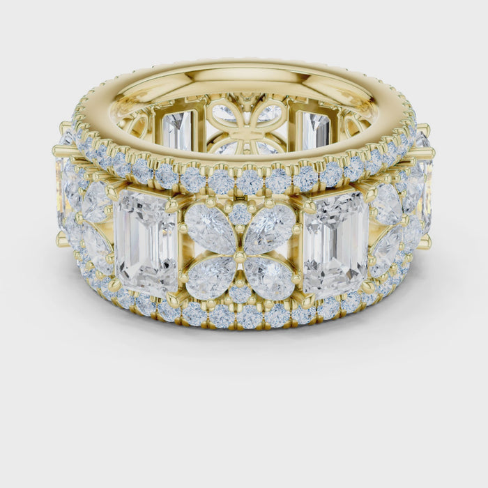 Video of yellow gold emerald floral cluster eternity band highlighting pavé setting and milgrain border