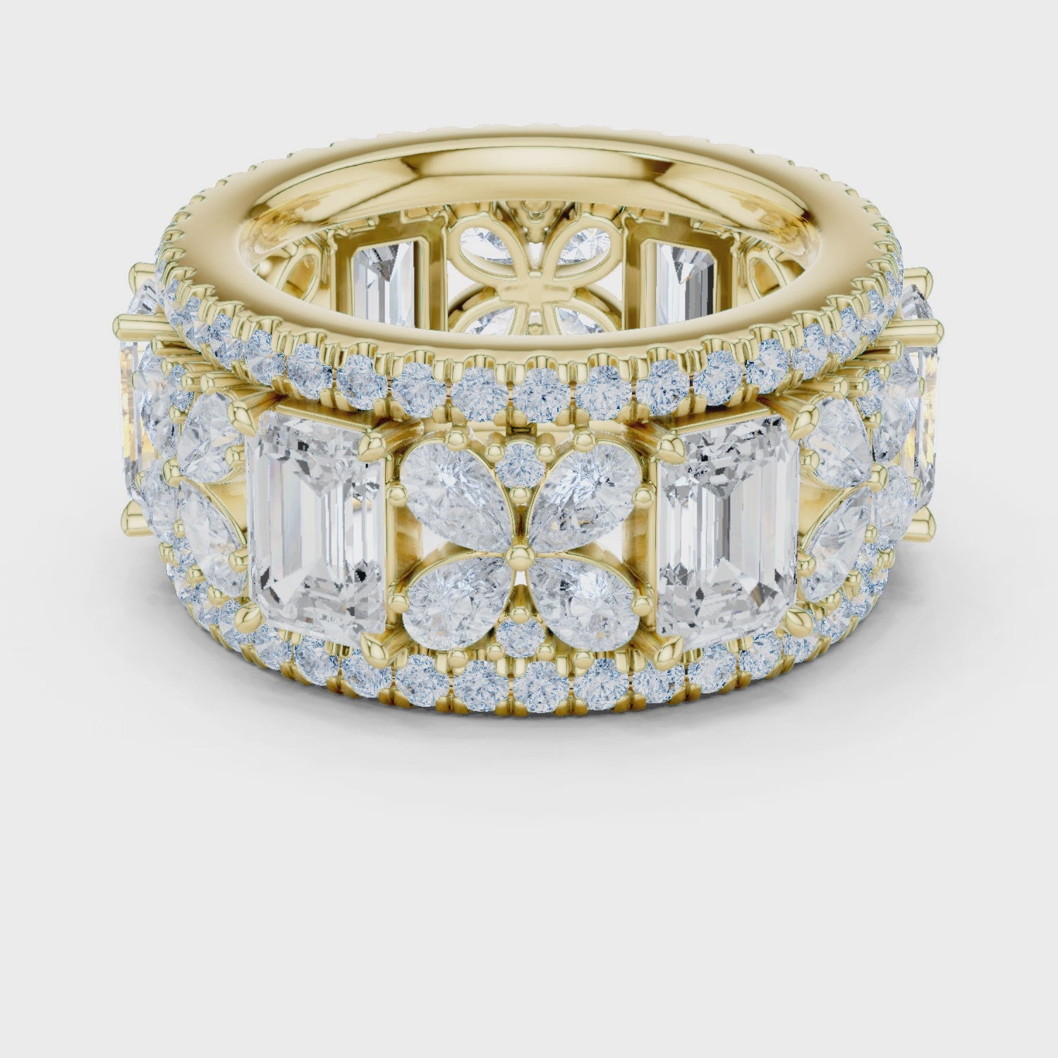 Video of yellow gold emerald floral cluster eternity band highlighting pavé setting and milgrain border