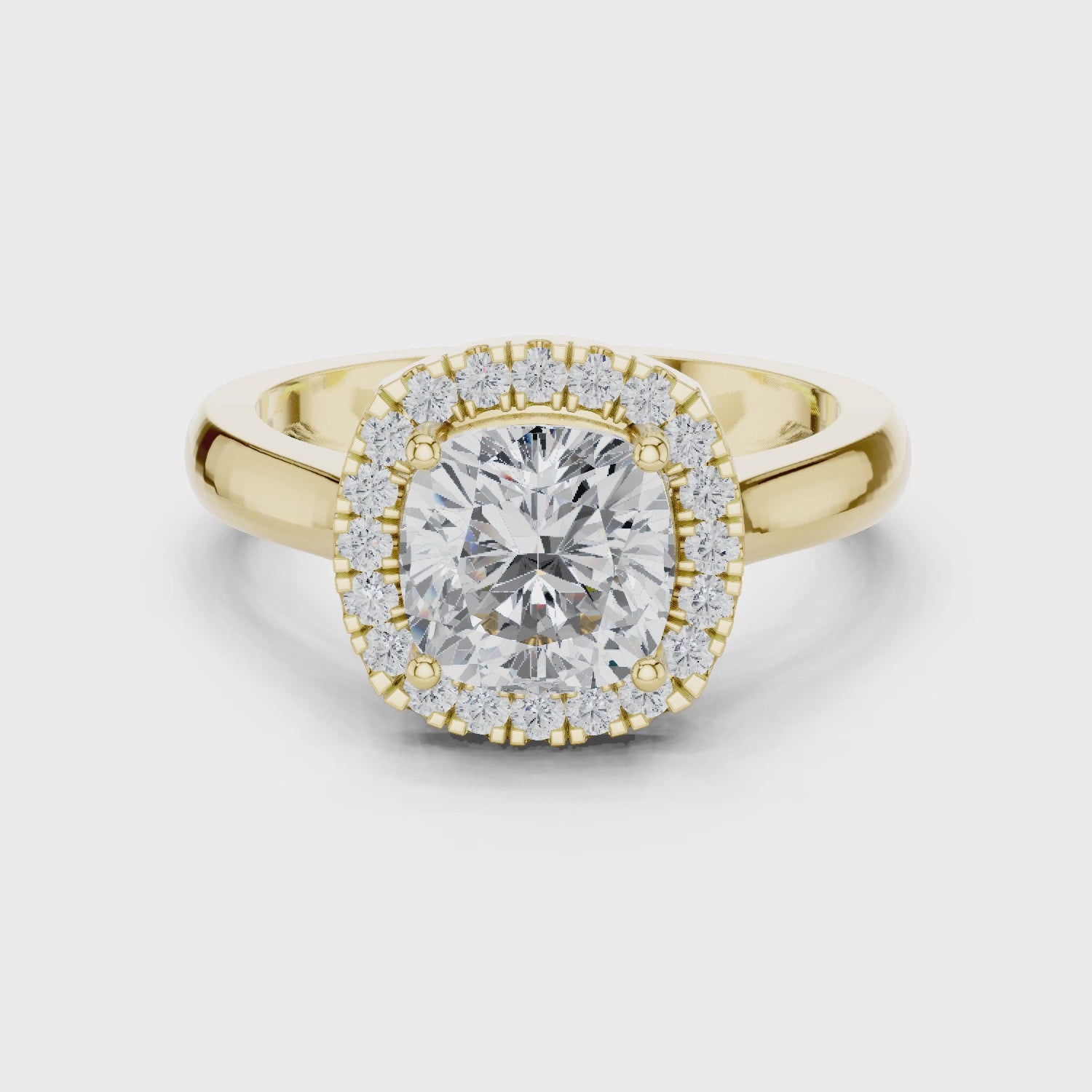 Video of yellow gold cushion halo ring highlighting diamond setting and structure