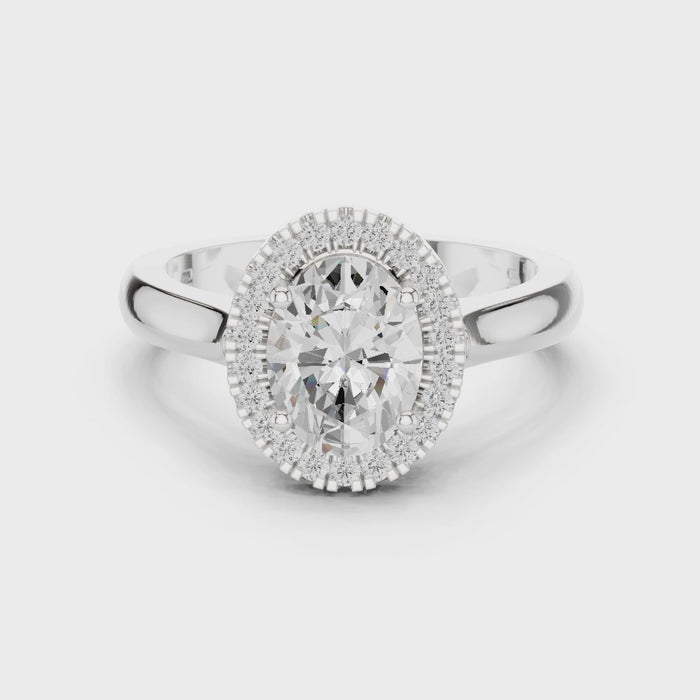 Video of white gold oval halo ring highlighting diamond setting and band profile