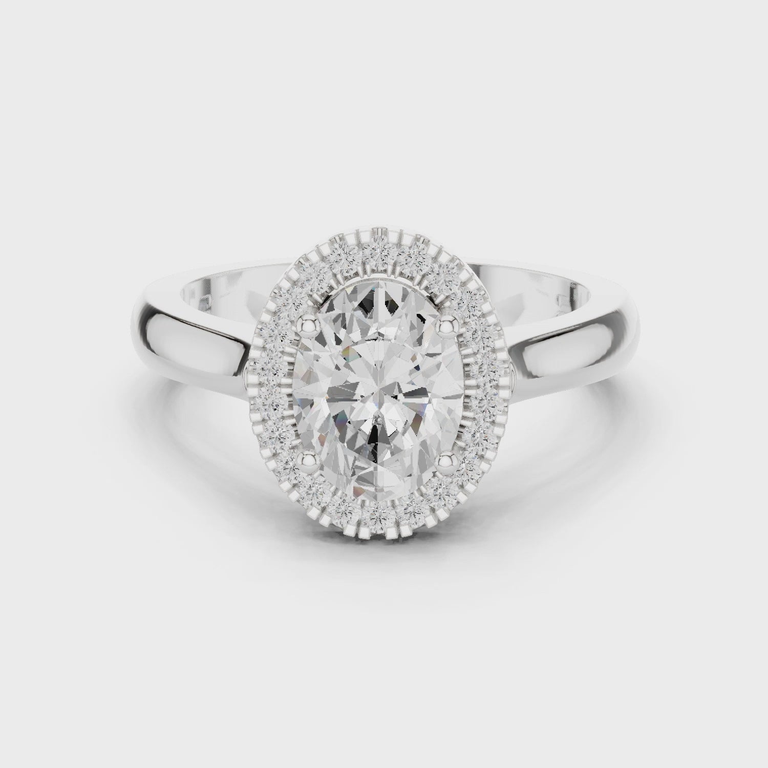 Video of white gold oval halo ring highlighting diamond setting and band profile