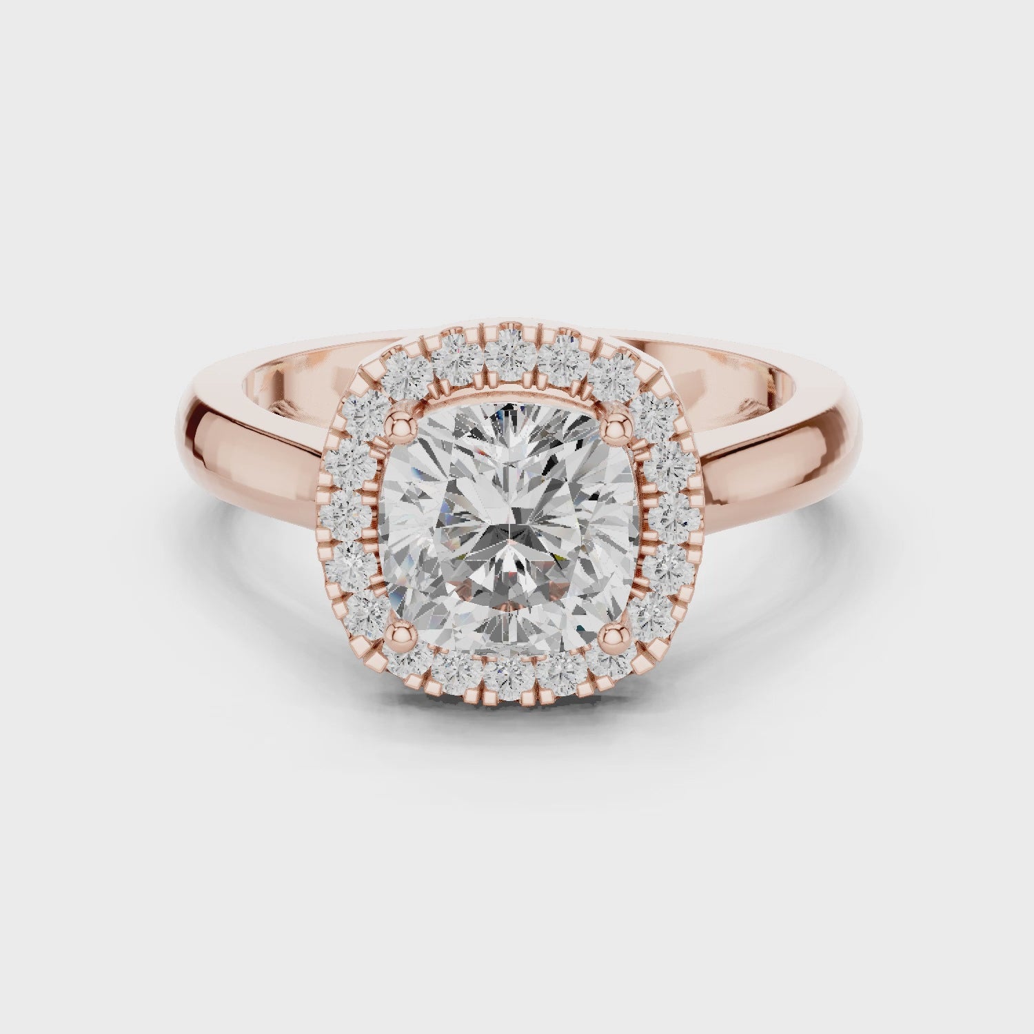 Video of rose gold cushion halo ring highlighting diamond setting and band profile