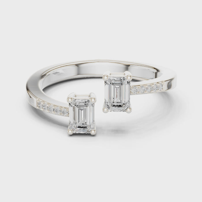 Video of white gold two stone ring highlighting double emerald setting and pavé band