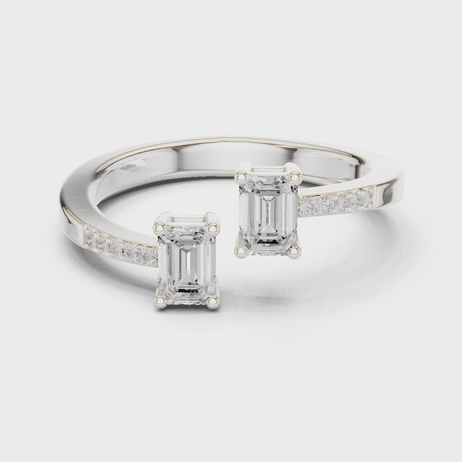 Video of white gold two stone ring highlighting double emerald setting and pavé band