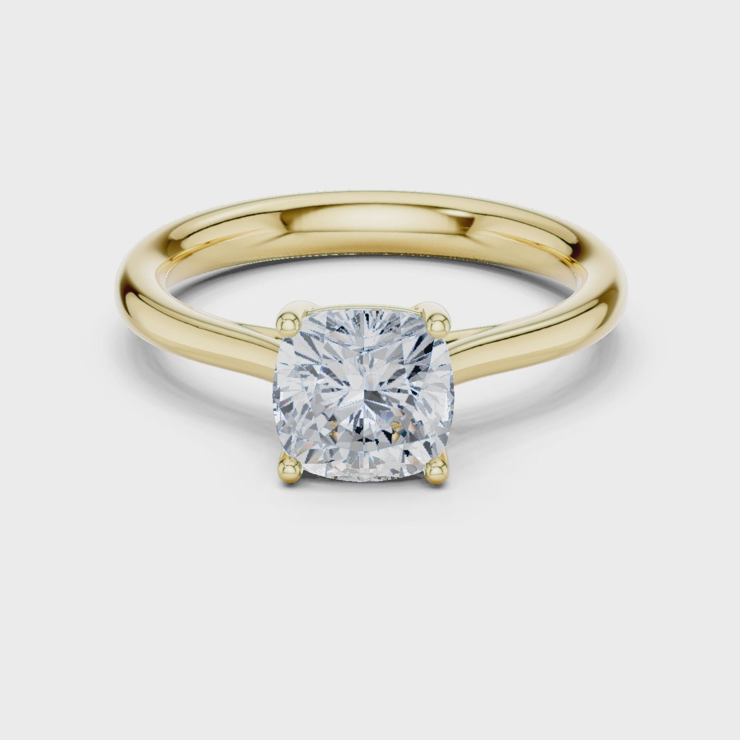 Video of yellow gold cushion cut solitaire ring highlighting elegant setting design