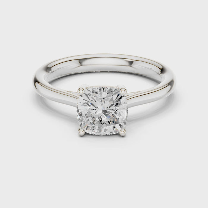 Video of white gold cushion cut solitaire ring highlighting setting and band profile
