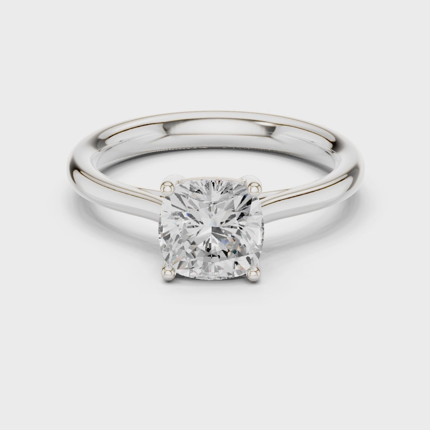 Video of white gold cushion cut solitaire ring highlighting setting and band profile