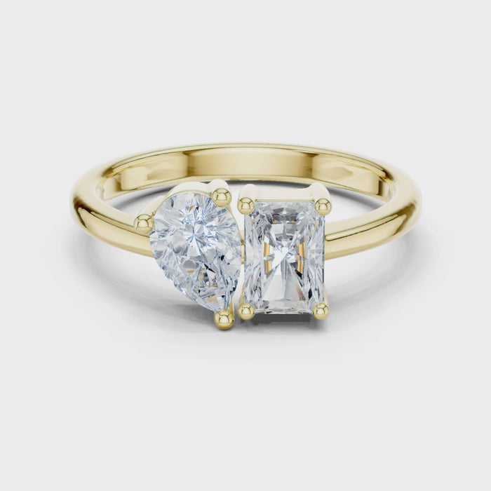Video of yellow gold Toi et Moi ring highlighting pear and radiant diamond setting