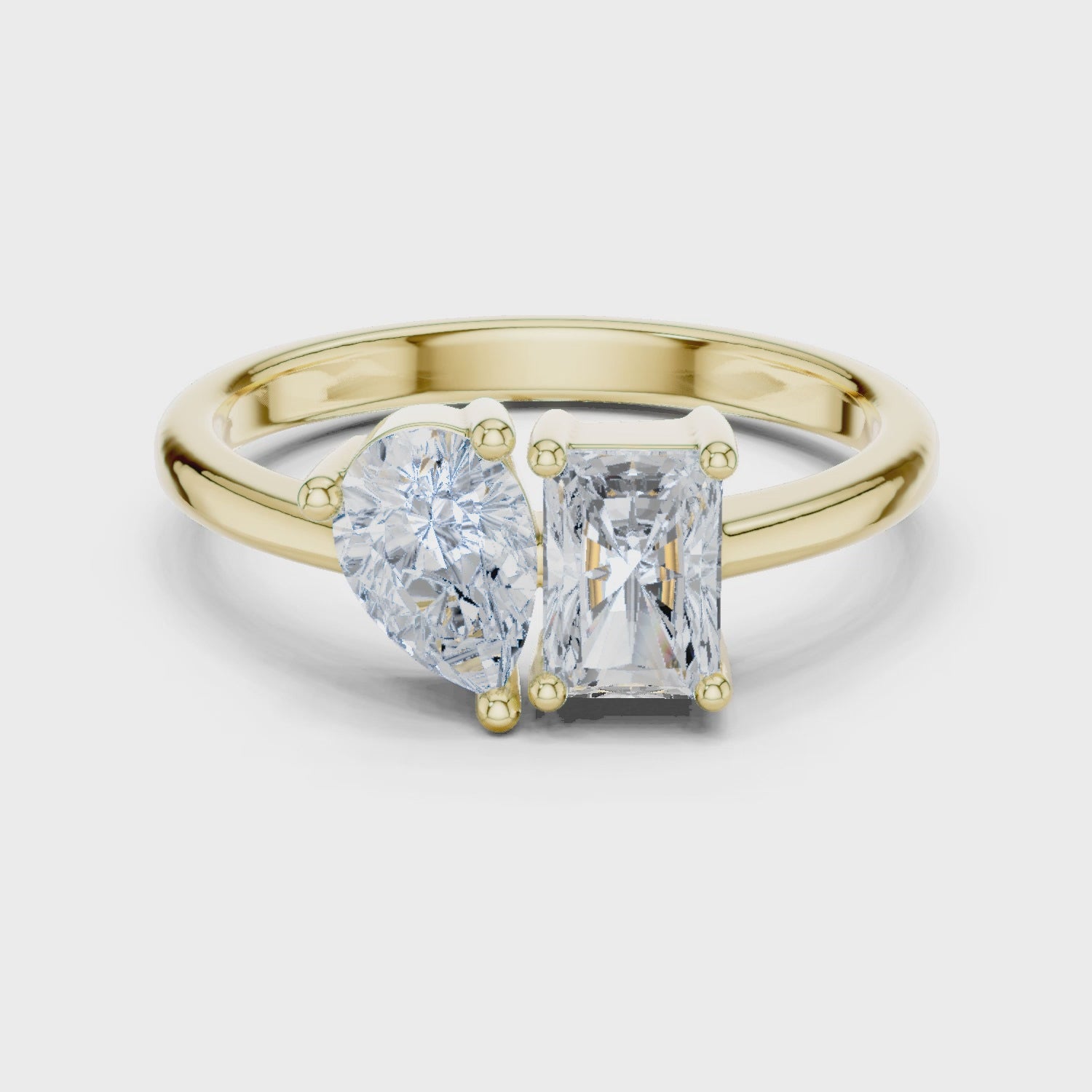 Video of yellow gold Toi et Moi ring highlighting pear and radiant diamond setting
