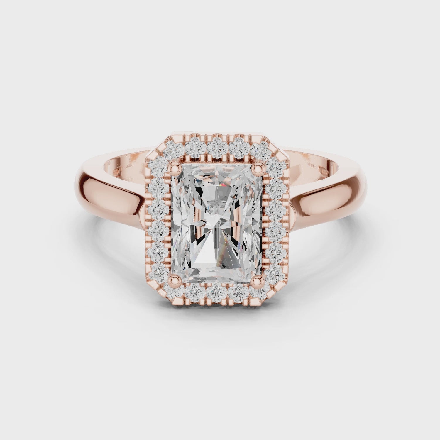 Video of rose gold radiant halo ring highlighting diamond setting and band profile