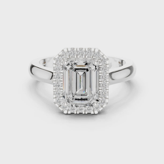 Video of white gold emerald halo ring highlighting diamond setting and band profile